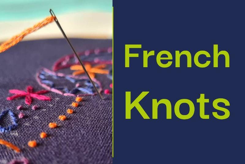 A close up of an embroidered elephant with orange French knots.