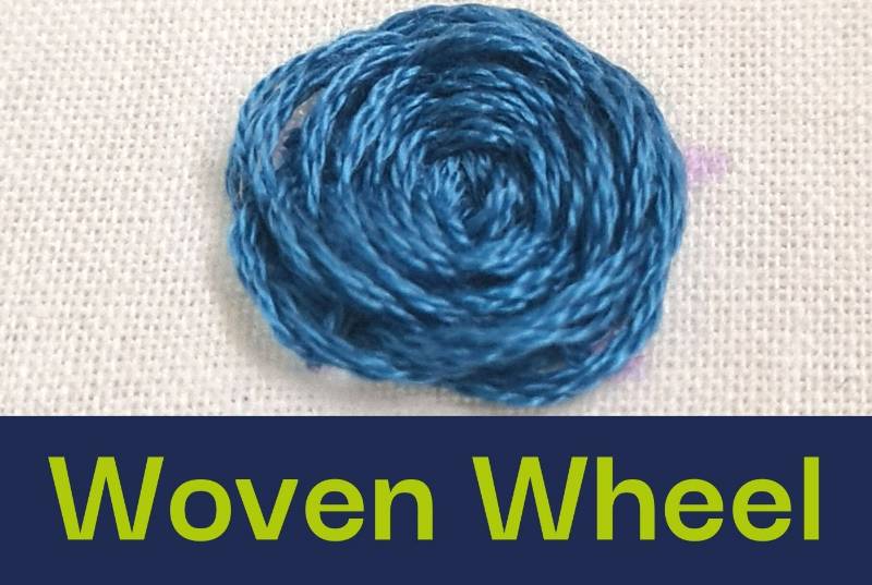 A close up of a woven wheel embroidery stitch.