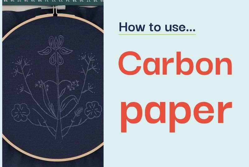 An embroidery hoop containing navy fabric with a floral design stencilled on it, alongside text saying 'how to use carbon paper'.