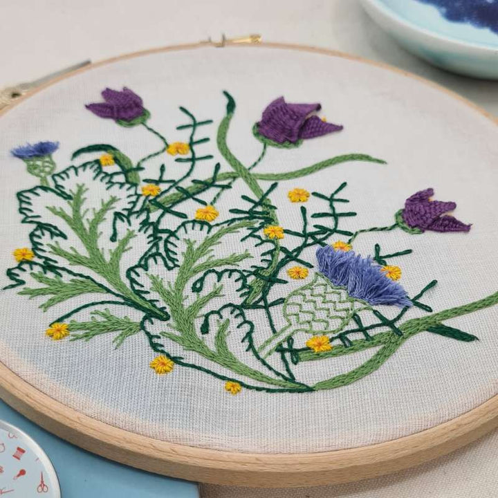 Close up photo of botanicals themed embroidery on a voile fabric