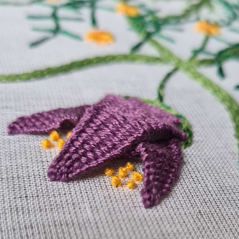 picot stitch in purple thread embroidered on voile fabric